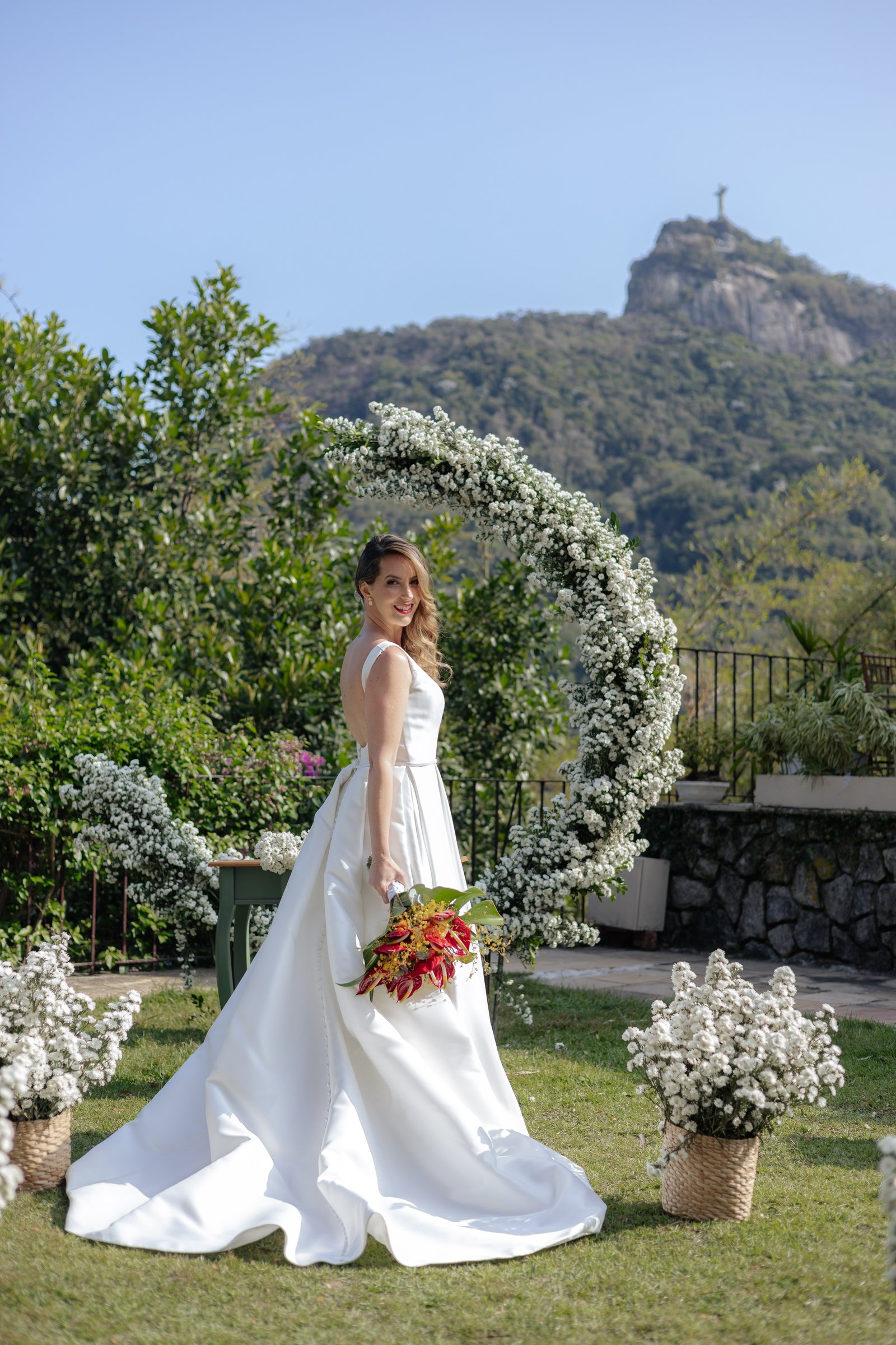 Bride with floral arch and Christ the Redeemer, destination wedding Rio de Janeiro
