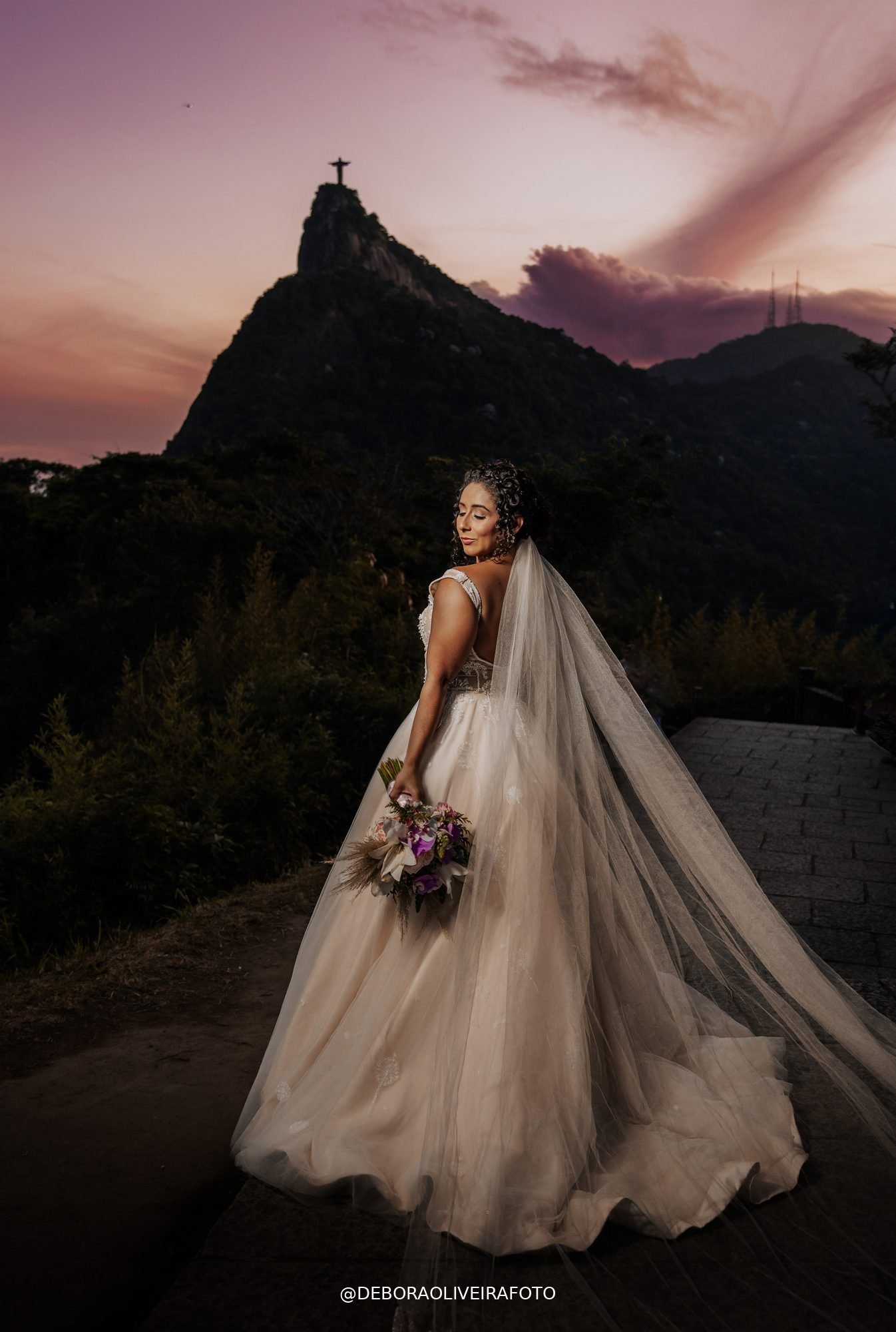 Bride with veil at dusk with Cristo Redentor - Rio de Janeiro elopement photography