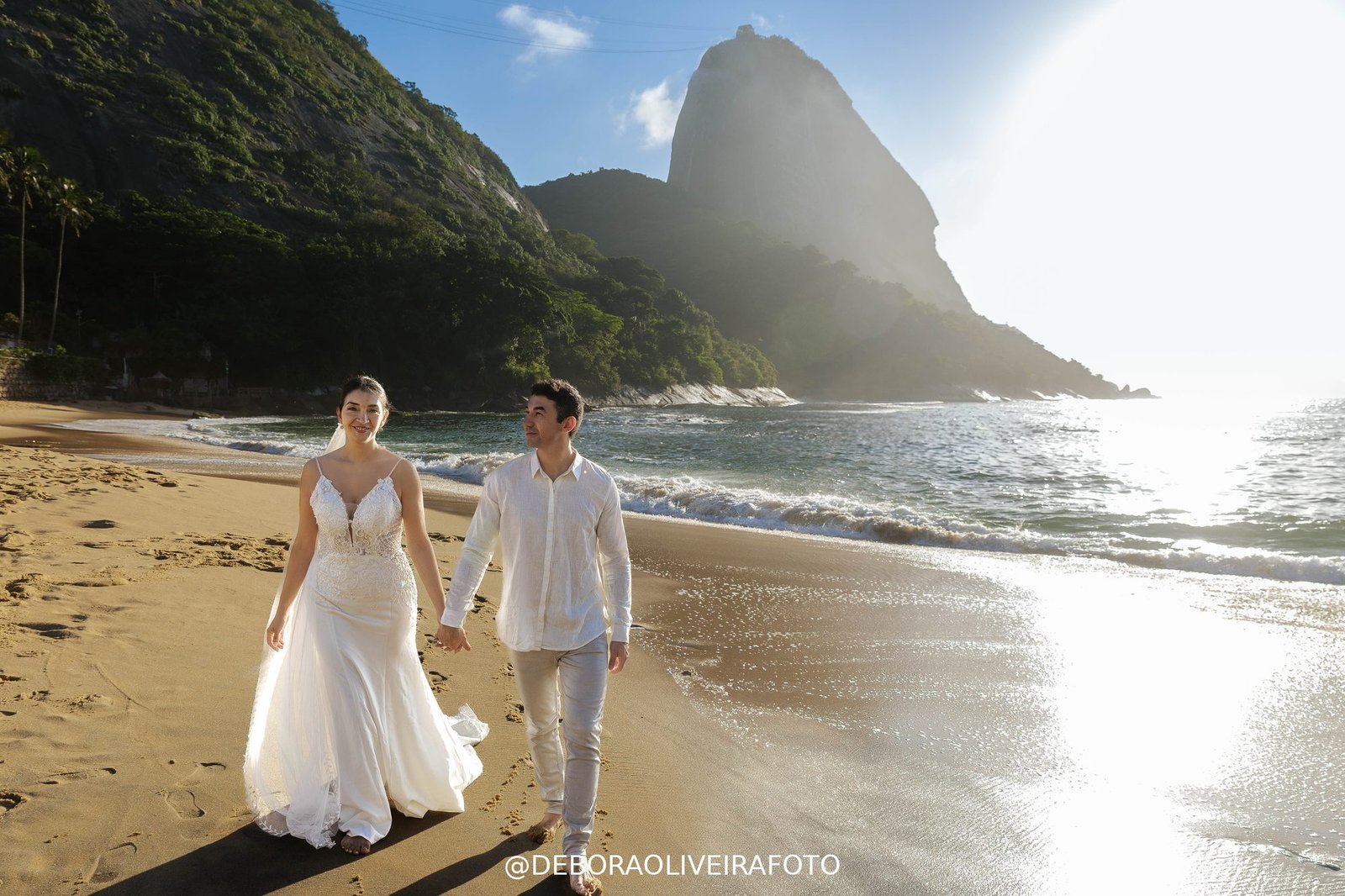 Couple walking on Praia Vermelha beach at sunrise with Sugarloaf Mountain - Rio de Janeiro elopement